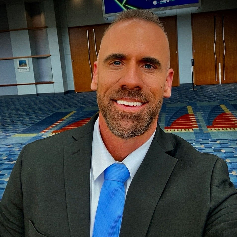 Dr. Adam Christman in a suit