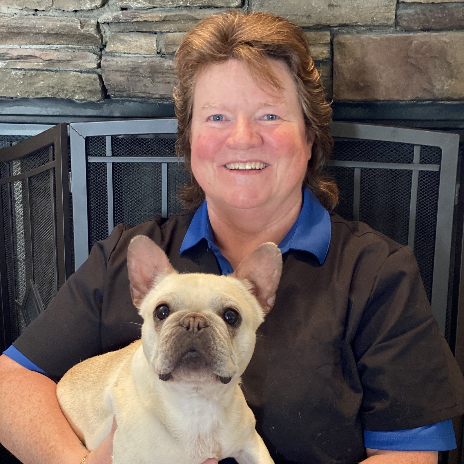 Kara Burns holding a French bulldog puppy